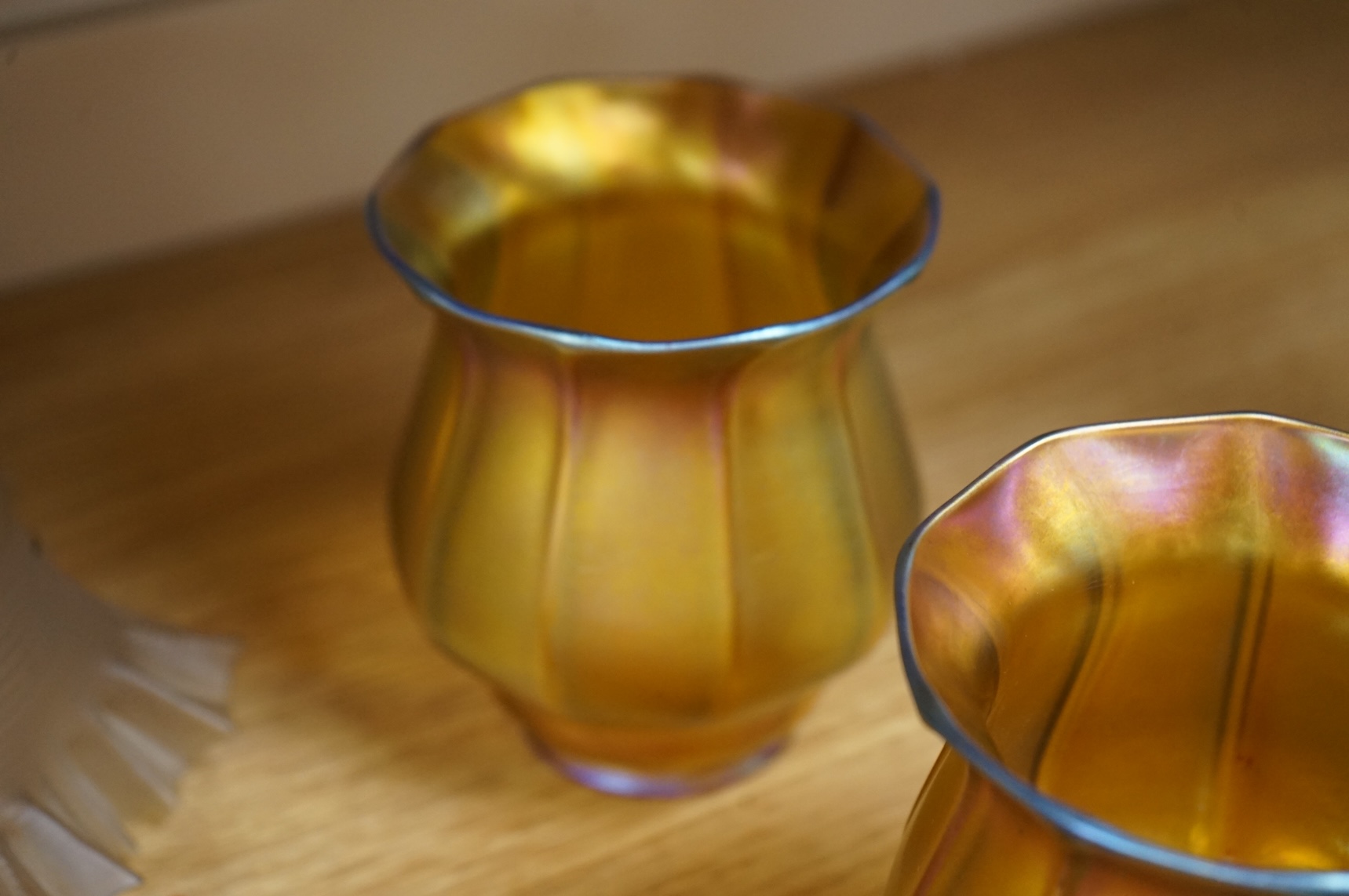 A pair of Quezal Art Glass iridescent light shades, and two frilled edged shades, Quezal shades 11.5cm high